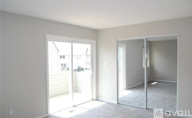 A room with a sliding glass door leading to a backyard.
