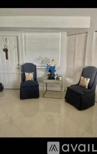 A living room with two chairs and a table.