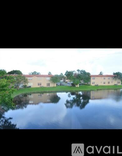 A building is reflected in the water in front of it.