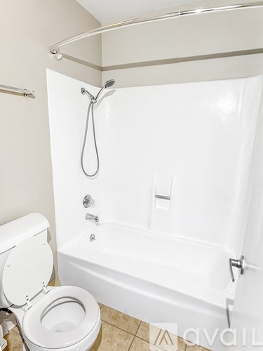 A white toilet is next to a white bathtub in a bathroom.