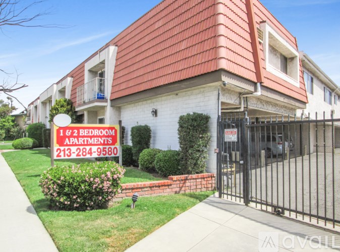A sign in front of a building advertises 1 and 2 bedroom apartments.