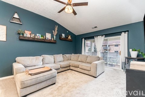 A living room with a large sectional sofa and a coffee table.