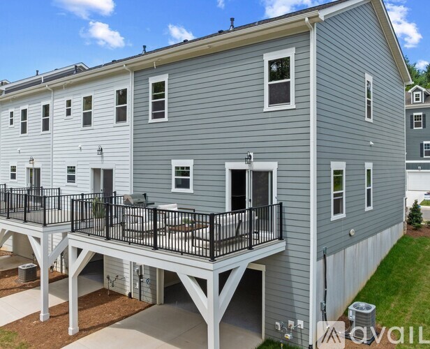 A two-story building with a balcony and a garage.