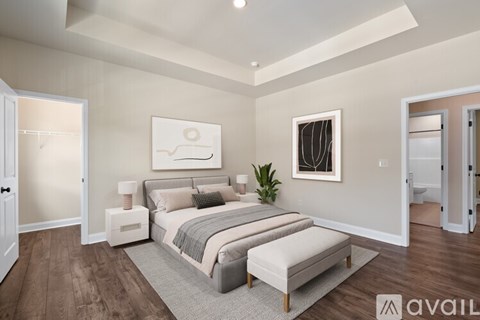 A bedroom with a large bed and a painting on the wall.