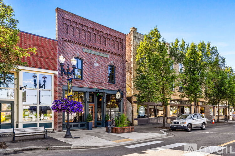 A street view of a town with a car parked on the side of the road.