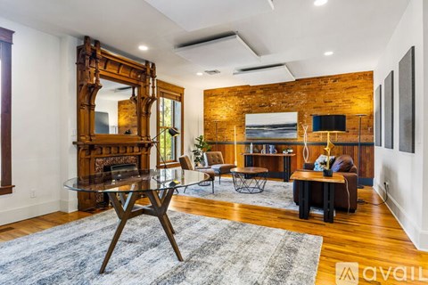 A living room with a glass table and a large mirror.
