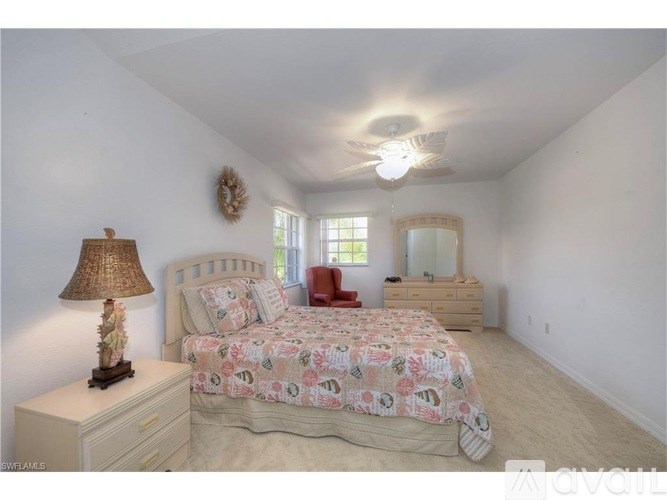 A bedroom with a bed, dresser, and mirror.