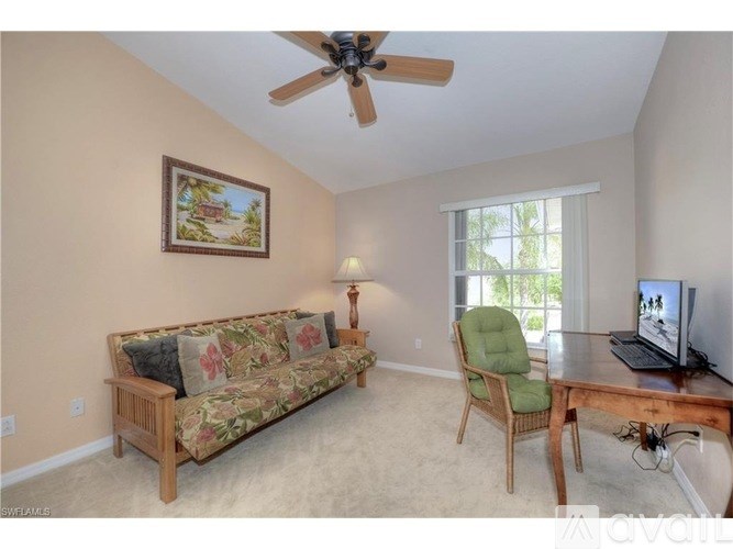 A living room with a couch, chair, and a painting on the wall.