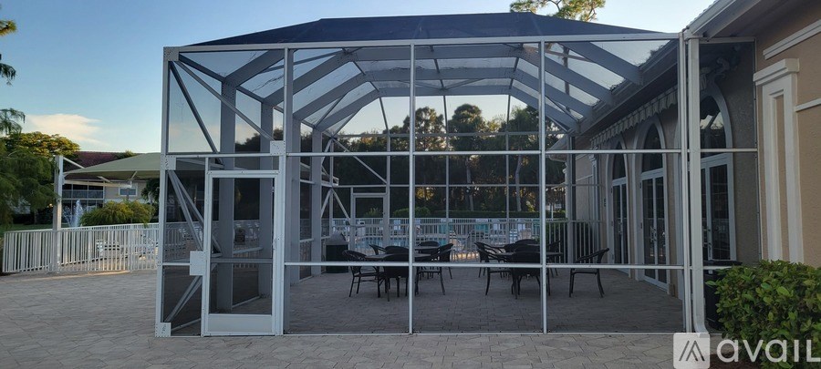 A bathroom with a large mirror, a sink, and a walk-in shower.