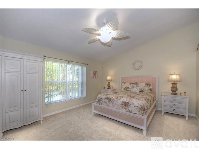 A bedroom with a bed, dresser, and ceiling fan.
