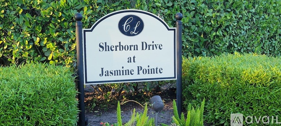 A large outdoor swimming pool surrounded by lounge chairs and trees.