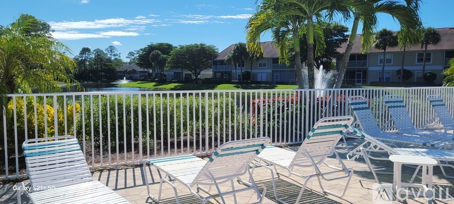 A bedroom with two beds, a dresser, and a painting on the wall.