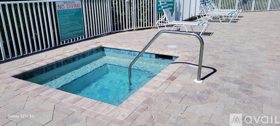 A bedroom with two beds and a desk.