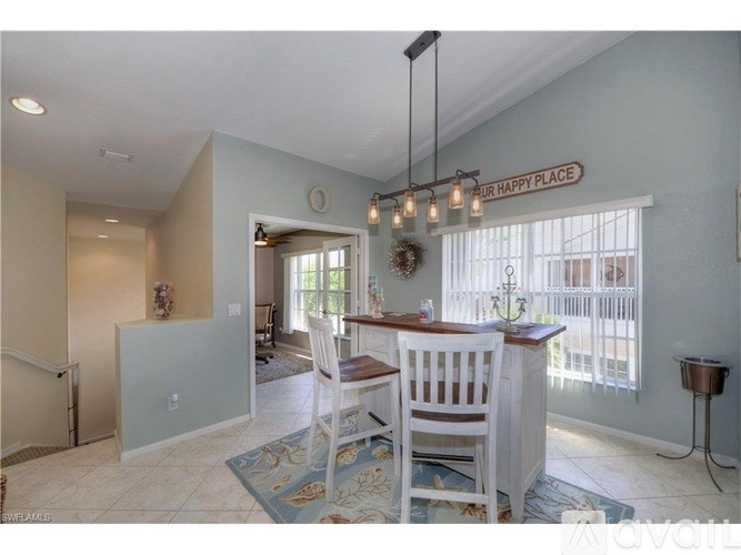 A dining area with a table and chairs and a sign that says "Our Happy Place".