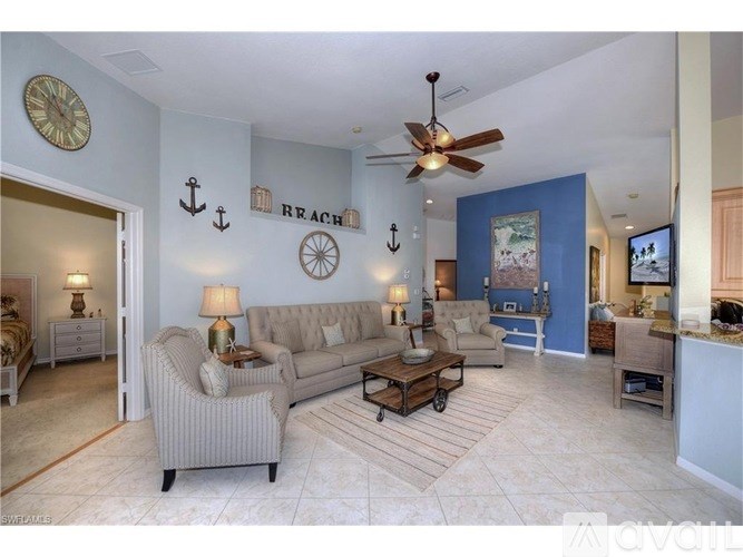 A living room with a grey sofa and a wooden coffee table.