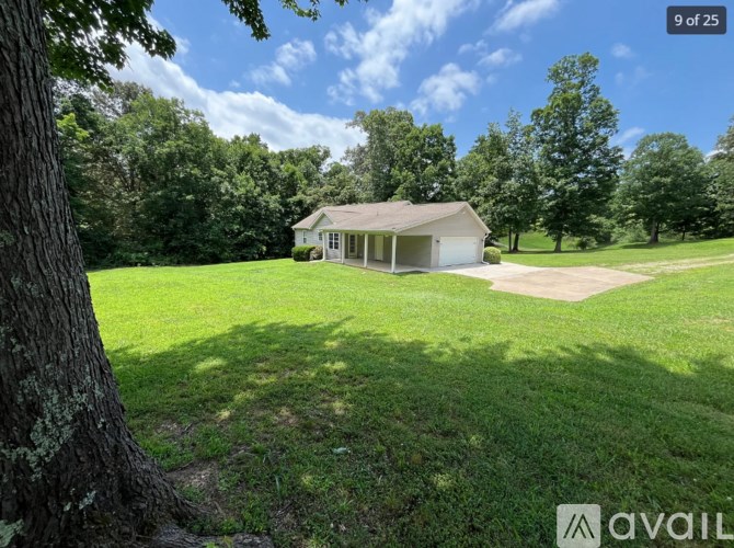A house is for sale in a green field.