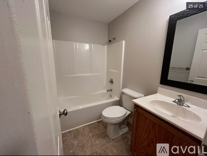 A bathroom with a toilet, sink, and bathtub.