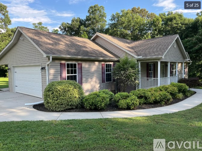 A house with a grey roof and a white garage door.