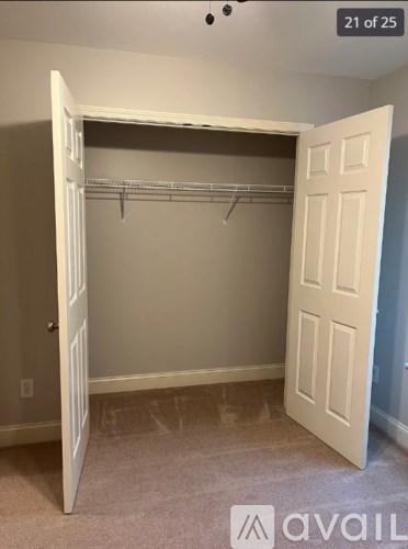 A white closet with a white door is open.