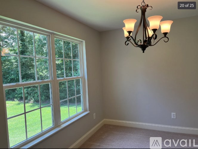 A room with a large window and a chandelier.