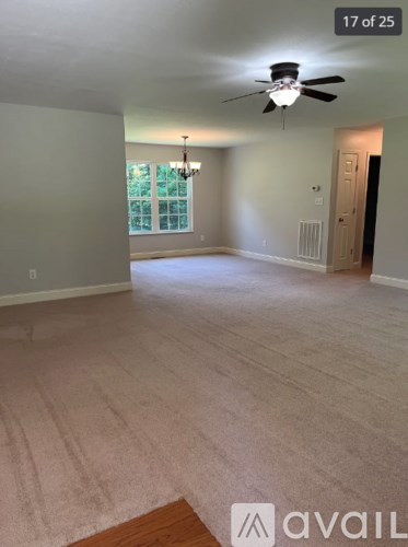 A room with a ceiling fan and a chandelier.