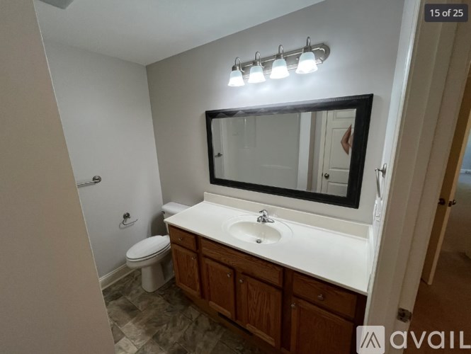 A bathroom with a white sink and a toilet.