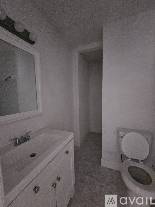 A bathroom with a toilet and sink.