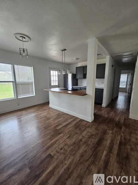 A kitchen with wooden floors and a white island.