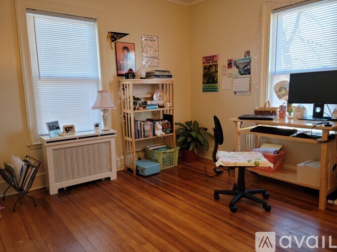 A room with a desk, chair, and bookshelf.