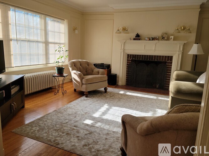 A living room with a fireplace and a chair.