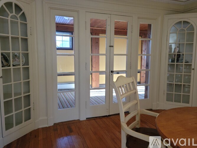 A room with a table, chairs and a window.