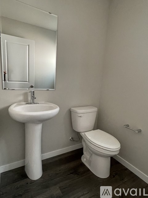 A white sink and toilet in a bathroom.
