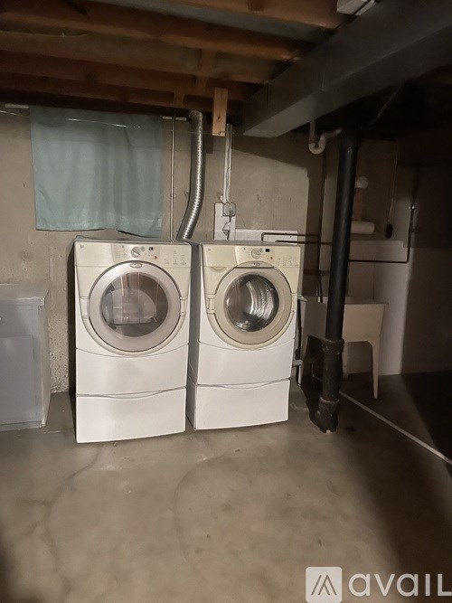 Two front loading washing machines in a laundry room.