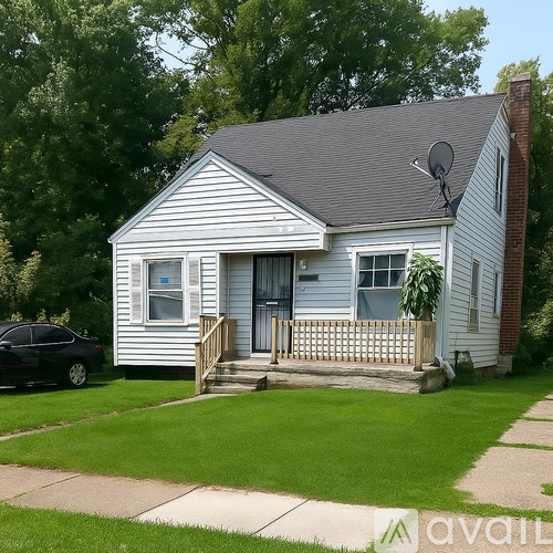 A small house with a porch and a car parked in front.