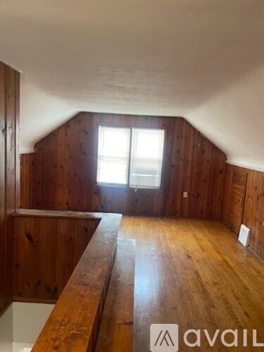 A room with wooden walls and a long wooden table.