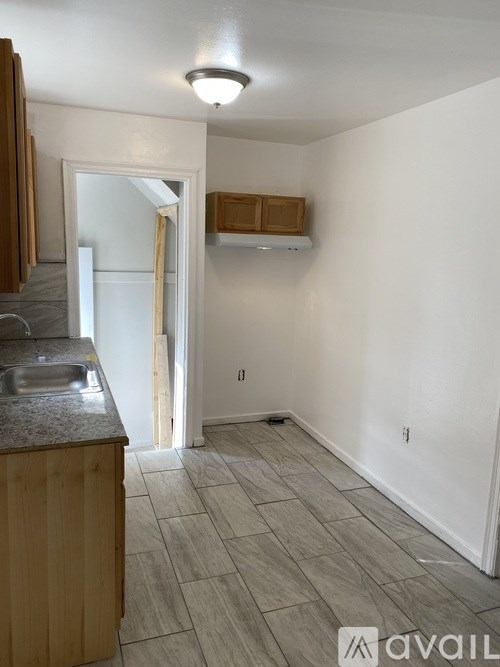 A kitchen area with a sink and a counter.