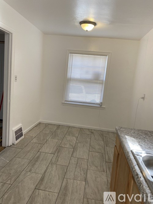 A kitchen with a sink and a window.