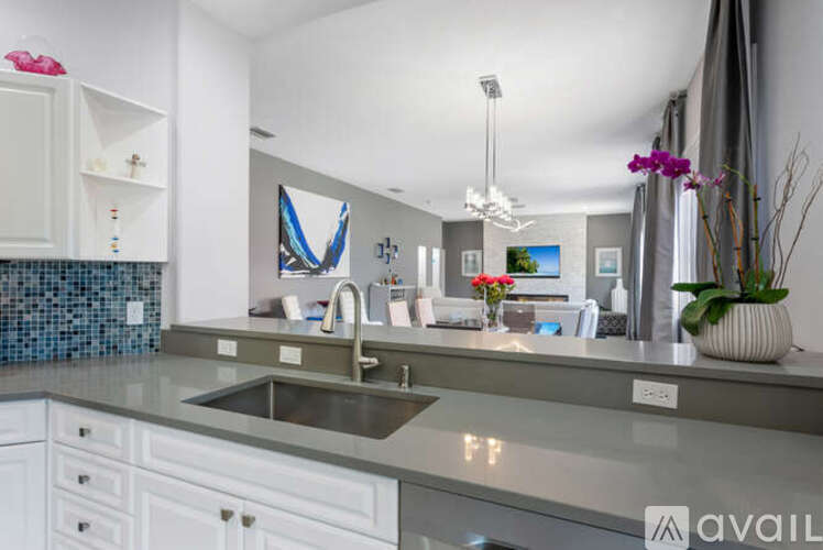 A modern kitchen with a sink and a counter.