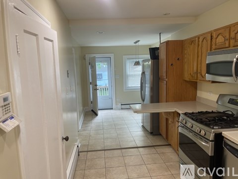 A kitchen with white cabinets and a white door.