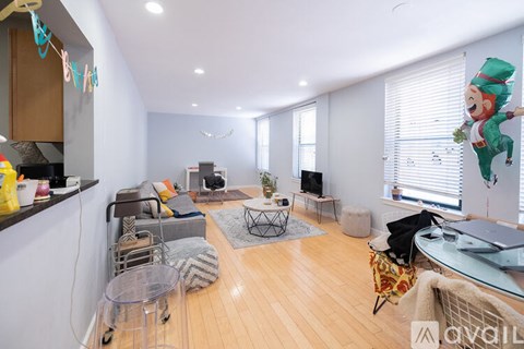 A living room with a glass table and a sofa.