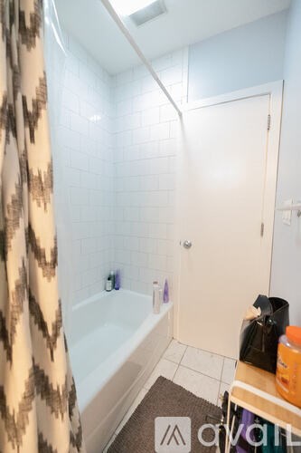 A small bathroom with a bathtub, a toilet, and a sink.