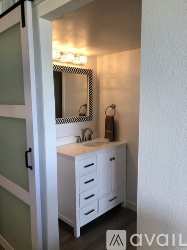 A bathroom with a sink and a mirror.