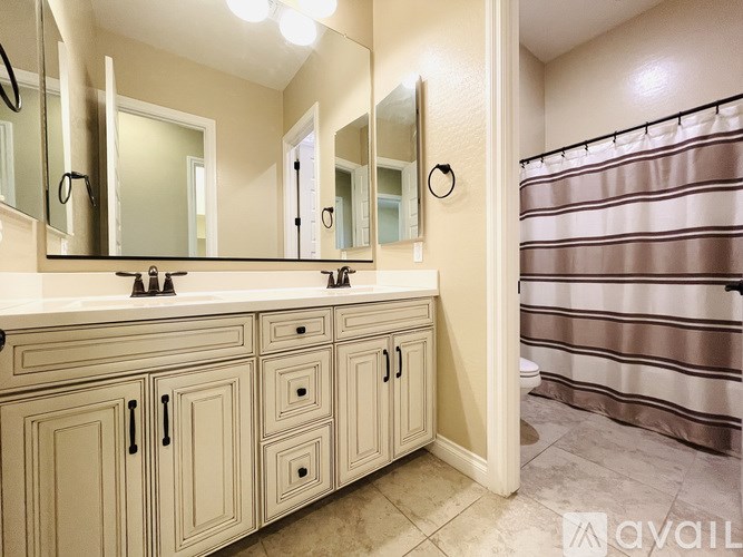 A bathroom with a vanity and a shower.