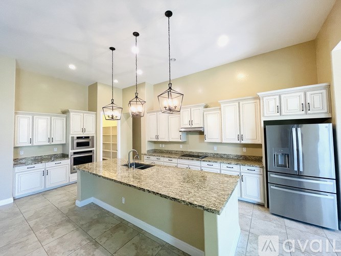A kitchen with granite countertops and stainless steel appliances.