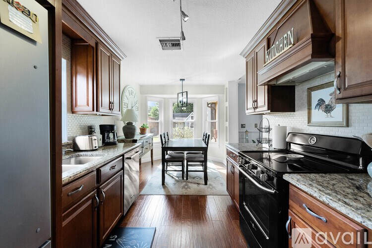 A kitchen with wooden cabinets and a black stove top oven.