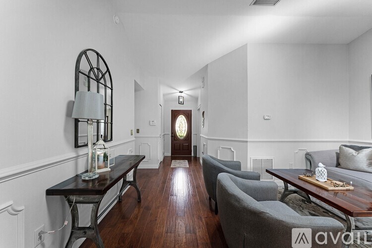 A living room with a grey couch and a wooden coffee table.