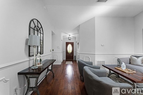 A living room with a grey couch and a wooden coffee table.