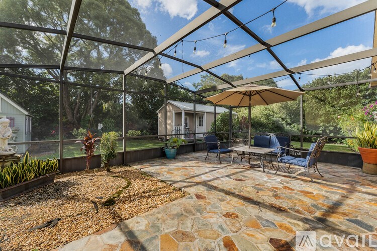 A patio with a table and chairs under a canopy.