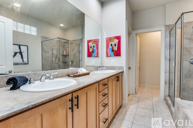 A room with a TV, chairs, and a painting on the wall.