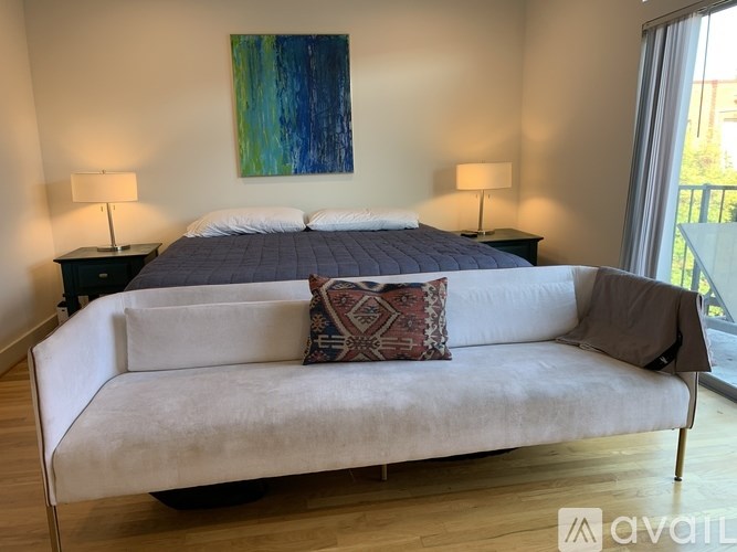 A bedroom with a large bed and a couch.